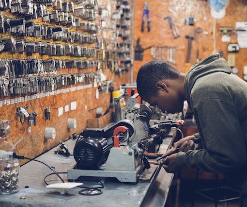 Man with grey hoodie working in with machine