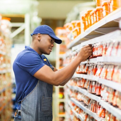 Happy African American hardware store worker working in the shop
