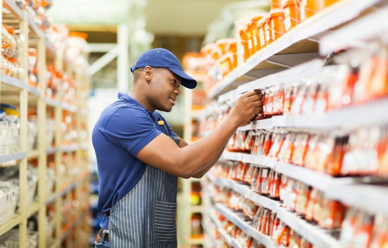 Happy African American hardware store worker working in the shop