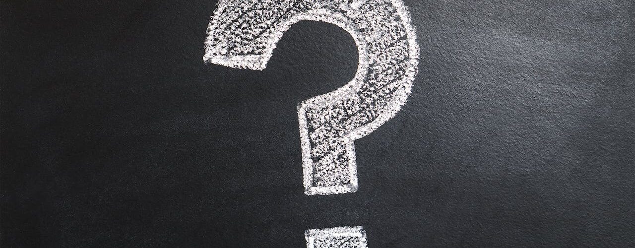Question mark written/drawn on a black board